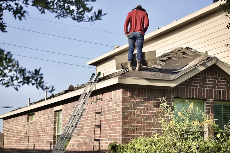 Professional roofer working on a residential roof in Lexington Court